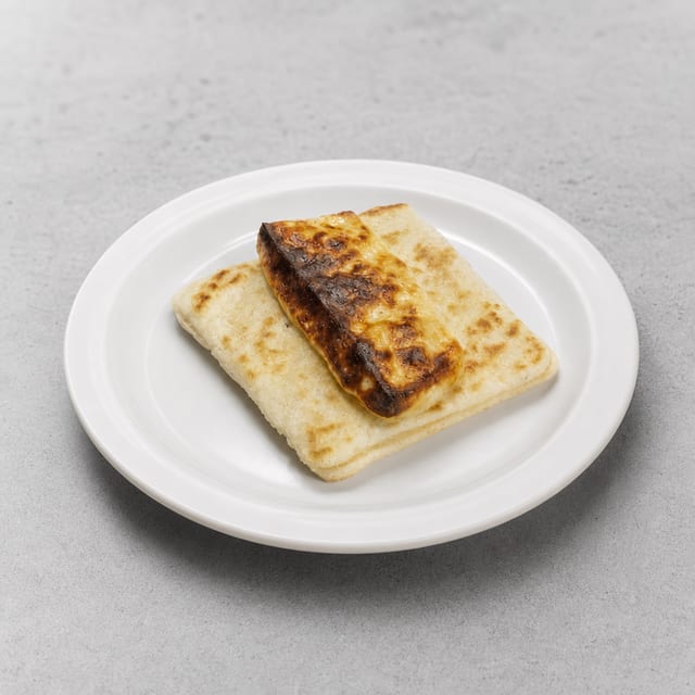 Arepa Con Doble Queso / Corn Cake with Melted Cheese.
